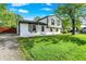 Charming two-story home with freshly cut lawn, bright white siding, black trim, and lovely curb appeal at 8103 Laughlin Dr, Indianapolis, IN 46219