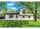 Charming two-story home with freshly cut lawn, bright white siding, black trim, and lovely curb appeal at 8103 Laughlin Dr, Indianapolis, IN 46219
