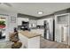 Bright kitchen with white cabinets, stainless steel appliances, a mosaic backsplash, and butcher block island at 8103 Laughlin Dr, Indianapolis, IN 46219