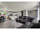 Open-concept living space flows into a modern white kitchen, complemented by gray walls and sleek, wood-look flooring at 8103 Laughlin Dr, Indianapolis, IN 46219