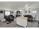 Spacious living room features a ceiling fan, dinette set and a comfortable leather sectional at 8103 Laughlin Dr, Indianapolis, IN 46219