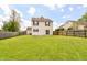 Spacious backyard featuring a large grassy area and secure wooden fence at 8108 Amarillo Dr, Indianapolis, IN 46237