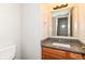 Bathroom vanity featuring a granite countertop, faucet, and framed mirror at 8108 Amarillo Dr, Indianapolis, IN 46237