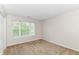 Neutral bedroom has a window providing light and plush carpet at 8108 Amarillo Dr, Indianapolis, IN 46237