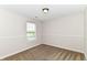 Bright bedroom with a window and plush carpet at 8108 Amarillo Dr, Indianapolis, IN 46237