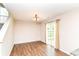 Dining room with hardwood floors, modern lighting, and a sliding door leading to backyard at 8108 Amarillo Dr, Indianapolis, IN 46237