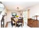 Cozy dining room with hardwood floors, chandelier, and a sliding glass door to the backyard at 8108 Amarillo Dr, Indianapolis, IN 46237
