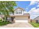Charming two-story home with a well-manicured lawn, brick accents, and an attached two-car garage at 8108 Amarillo Dr, Indianapolis, IN 46237