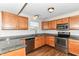 Kitchen featuring stainless steel appliances, granite countertop, and wooden cabinets at 8108 Amarillo Dr, Indianapolis, IN 46237