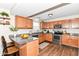 Kitchen featuring wood cabinets, stainless steel appliances, granite countertops, and hardwood floors at 8108 Amarillo Dr, Indianapolis, IN 46237