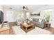 Bright living room featuring stylish furniture, hardwood floors, a ceiling fan, and natural light at 8108 Amarillo Dr, Indianapolis, IN 46237