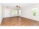 Spacious living room with hardwood floors, ceiling fan, and natural light from multiple windows at 8108 Amarillo Dr, Indianapolis, IN 46237