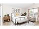 Staged bedroom with a neutral color palette, large windows, and decorative accents at 8108 Amarillo Dr, Indianapolis, IN 46237