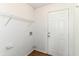 Mud room featuring a wooden floor, metal shelf, white door, and electrical outlets at 8108 Amarillo Dr, Indianapolis, IN 46237