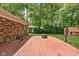 Backyard view showcasing a wooden deck, green lawn, and a storage shed, creating a relaxing outdoor space at 818 Merry Ln, Greenwood, IN 46142