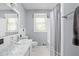 Bathroom featuring a tub/shower combo with a white tile surround and neutral walls at 818 Merry Ln, Greenwood, IN 46142
