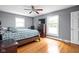 Cozy bedroom with hardwood floors, natural light and a ceiling fan for added comfort at 818 Merry Ln, Greenwood, IN 46142