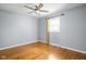 Light-filled bedroom featuring hardwood floors, neutral walls, and a ceiling fan for comfort at 818 Merry Ln, Greenwood, IN 46142