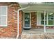 Close up featuring the front door of this brick home and stone tile flooring at 818 Merry Ln, Greenwood, IN 46142