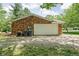 A detached garage showing the exterior brick finish, and utility access at 818 Merry Ln, Greenwood, IN 46142