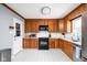 Well-maintained kitchen with wood cabinets, a black stove, and white countertops at 818 Merry Ln, Greenwood, IN 46142