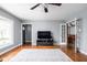 Cozy living room with wood floors, neutral walls, a ceiling fan, and lots of light at 818 Merry Ln, Greenwood, IN 46142