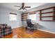 Bright home office with built-in shelving, hardwood floors, and a comfortable workspace at 818 Merry Ln, Greenwood, IN 46142