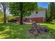Spacious backyard with mature trees, patio area, and a black truck parked on the side at 8227 Hoover Ln, Indianapolis, IN 46260