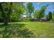 Expansive backyard with mature trees providing shade and privacy for outdoor enjoyment at 8227 Hoover Ln, Indianapolis, IN 46260