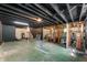 Unfinished basement with concrete floor, exposed beams, and potential for customization at 8227 Hoover Ln, Indianapolis, IN 46260