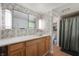 Bright bathroom featuring vanity storage, a vessel sink, and decorative wallpaper at 8227 Hoover Ln, Indianapolis, IN 46260