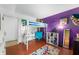 Stylish bedroom featuring a lofted bed with desk space underneath and purple walls at 8227 Hoover Ln, Indianapolis, IN 46260