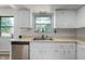 Bright kitchen shows ample counter space, stainless steel dishwasher and white cabinetry at 8227 Hoover Ln, Indianapolis, IN 46260