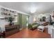Inviting living room featuring built-in shelving, a comfortable green sofa, and an open layout at 8227 Hoover Ln, Indianapolis, IN 46260