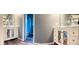 Bathroom with vanity with unique mirrored doors and shower with blue curtain in background at 8627 Lansdowne Dr, Fishers, IN 46038