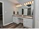 Bright bathroom featuring a double vanity with granite countertop and modern lighting at 8627 Lansdowne Dr, Fishers, IN 46038