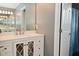 Bathroom featuring a vanity with decorative mirrored doors and quartz countertop at 8627 Lansdowne Dr, Fishers, IN 46038