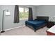 Well-lit bedroom with a plush blue bed and window view at 8627 Lansdowne Dr, Fishers, IN 46038