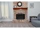 Close-up view of the brick fireplace with decorative mantle, clock, and cozy ambiance at 8627 Lansdowne Dr, Fishers, IN 46038