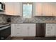Kitchen featuring stainless appliances and tile backsplash at 8627 Lansdowne Dr, Fishers, IN 46038