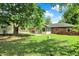 Large grassy backyard with a view of the house and sunroom at 8834 W 1050 S, Fortville, IN 46040