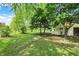 Spacious backyard with mature trees and green grass at 8834 W 1050 S, Fortville, IN 46040