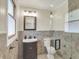 Well-lit bathroom featuring a vanity, mirror, and tiled shower at 8834 W 1050 S, Fortville, IN 46040