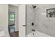 Elegant bathroom featuring marble tiled shower, black hardware and a plant in the niche at 8834 W 1050 S, Fortville, IN 46040