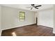 A comfortable bedroom with hardwood floors, large window, and closet space at 8834 W 1050 S, Fortville, IN 46040
