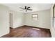 Bright bedroom featuring hardwood floors, neutral walls, and a ceiling fan at 8834 W 1050 S, Fortville, IN 46040