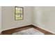 Cozy bedroom with hardwood floors, a window offering a view of the greenery, and modern rug at 8834 W 1050 S, Fortville, IN 46040