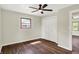 Well-lit bedroom featuring a ceiling fan, a closet and windows at 8834 W 1050 S, Fortville, IN 46040