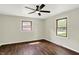 Bright bedroom with hardwood floors, a ceiling fan, and natural light streaming through windows at 8834 W 1050 S, Fortville, IN 46040