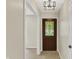 Welcoming foyer with tiled floors, contemporary lighting, and a beautifully detailed stained-glass front door at 8834 W 1050 S, Fortville, IN 46040